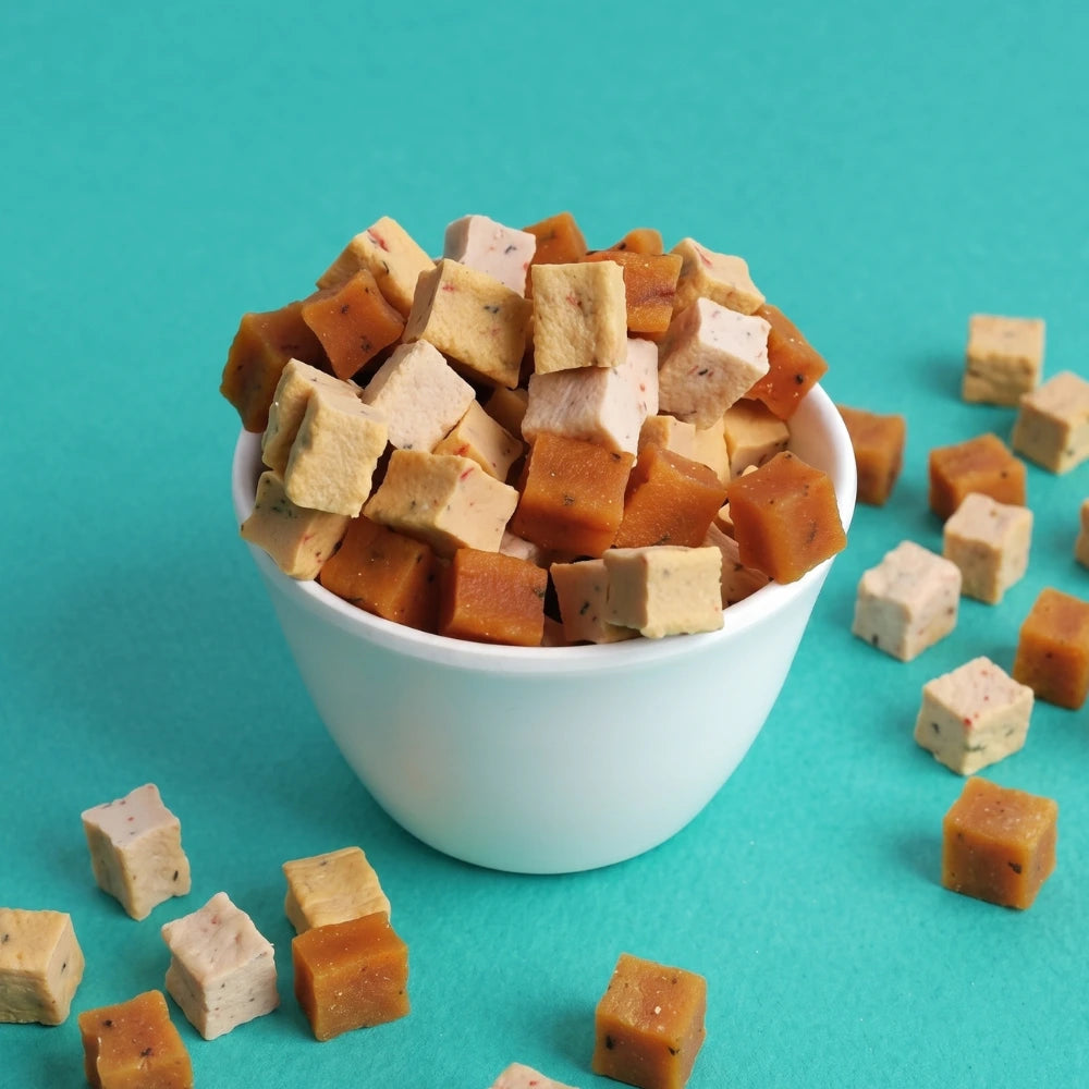 Cubed tofu in a white bowl on a teal background