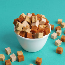 Cubed tofu in a white bowl on a teal background